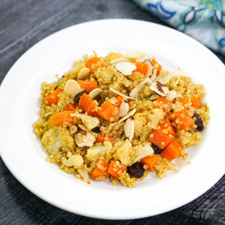 vegetable curry quinoa pilaf on white plate