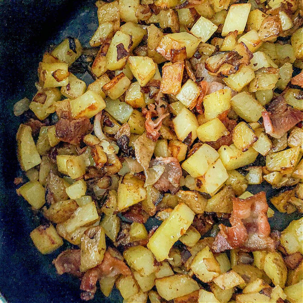 closeup of a pan of German fried potatoes with bacon 