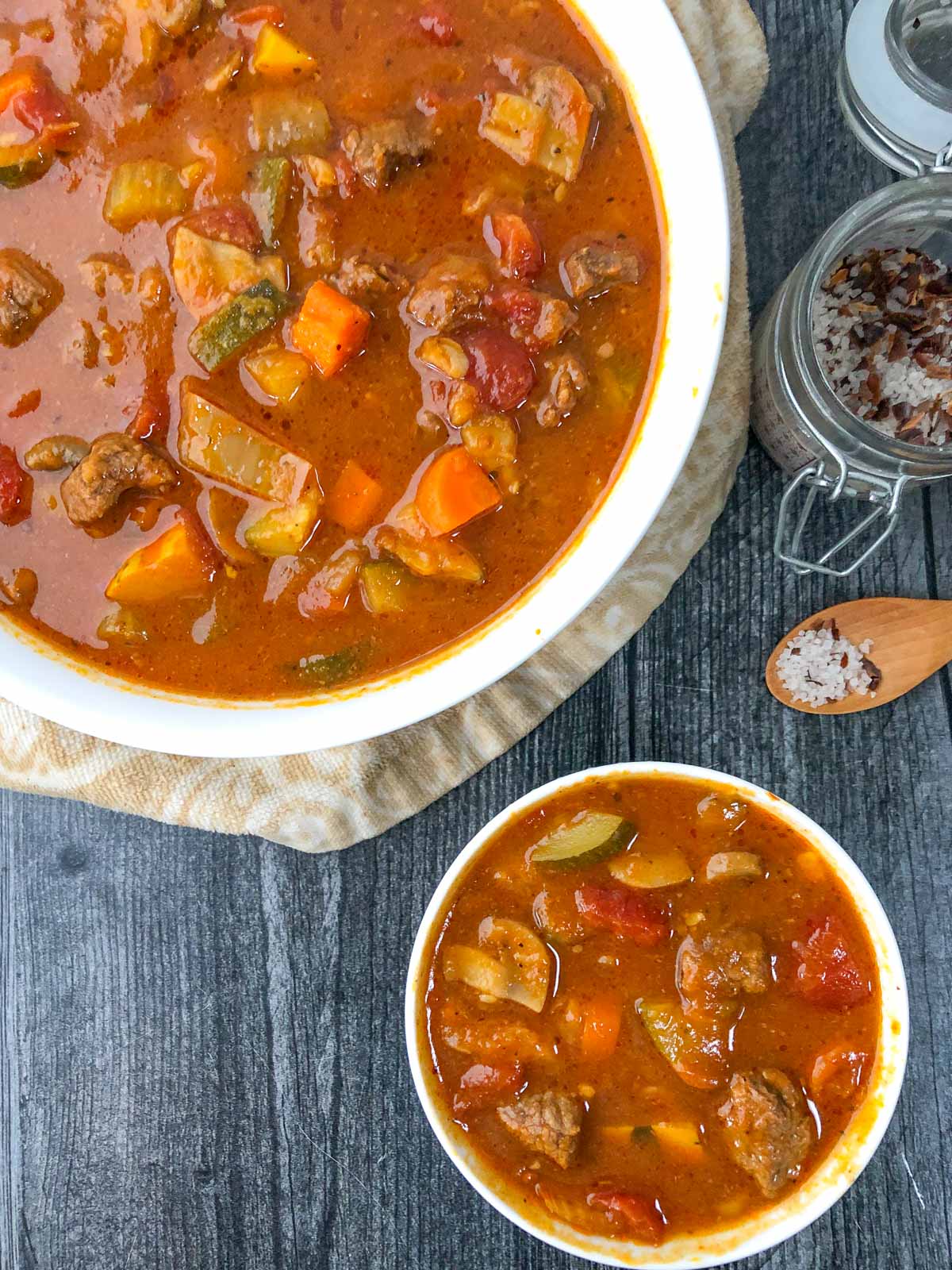 two white bowls with vegetable and beef stew