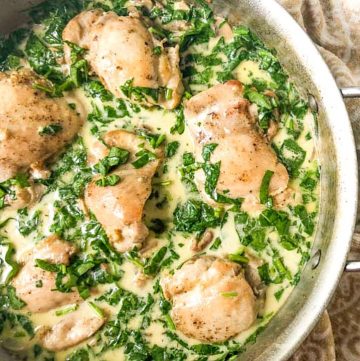 closeup of low carb creamy chicken with spinach and mushroom skillet