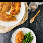 white plates with keto coconut crusted chicken and green beans and text