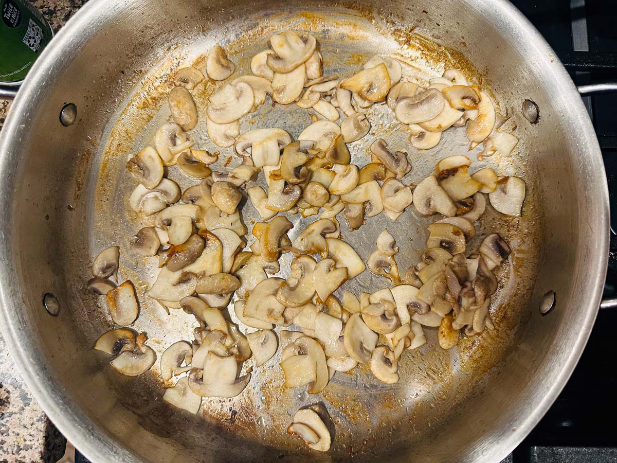 saute pan with browned mushroom slices