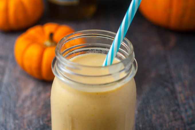 mason jar with salted caramel pumpkin  low carb smoothie and mini pumpkins in background