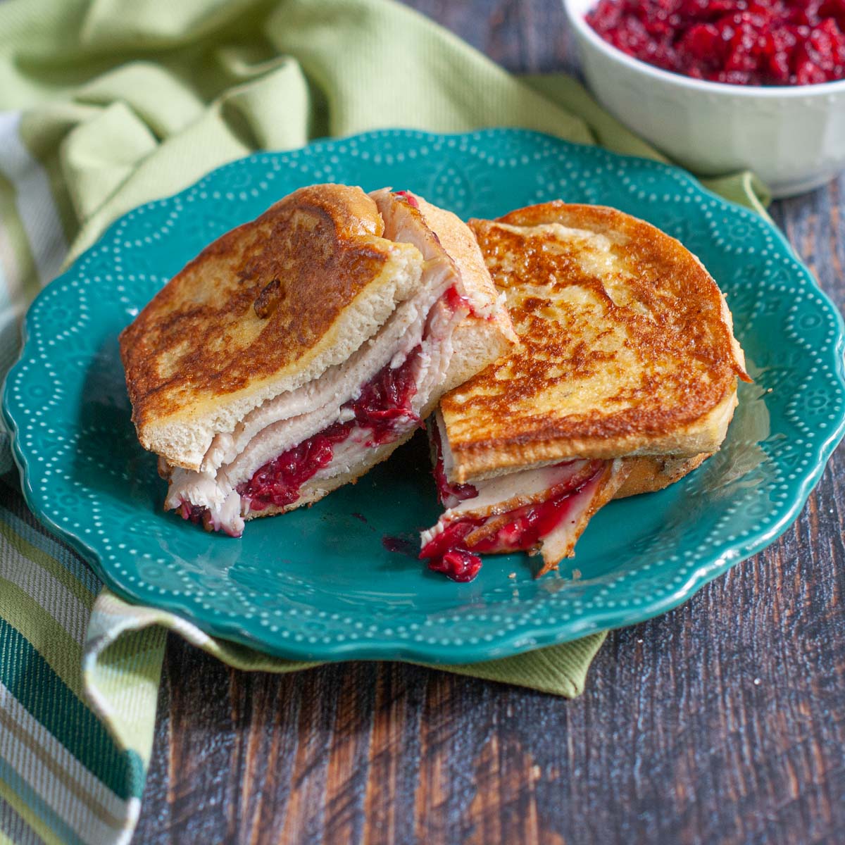 turkey and cranberry Cristo sandwich on green plate