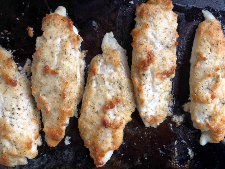Closeup of the keto baked tilapia filets on a cookie sheet