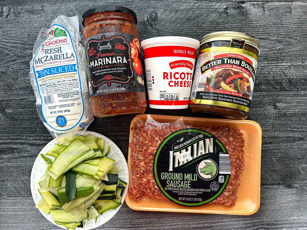 Recipe ingredients - marinara sauce, fresh mozzarella, zucchini noodles, Italian sausage, ricotta and better than bouillon.