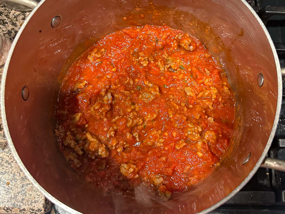 Soup pot with sausage and marinara sauce.