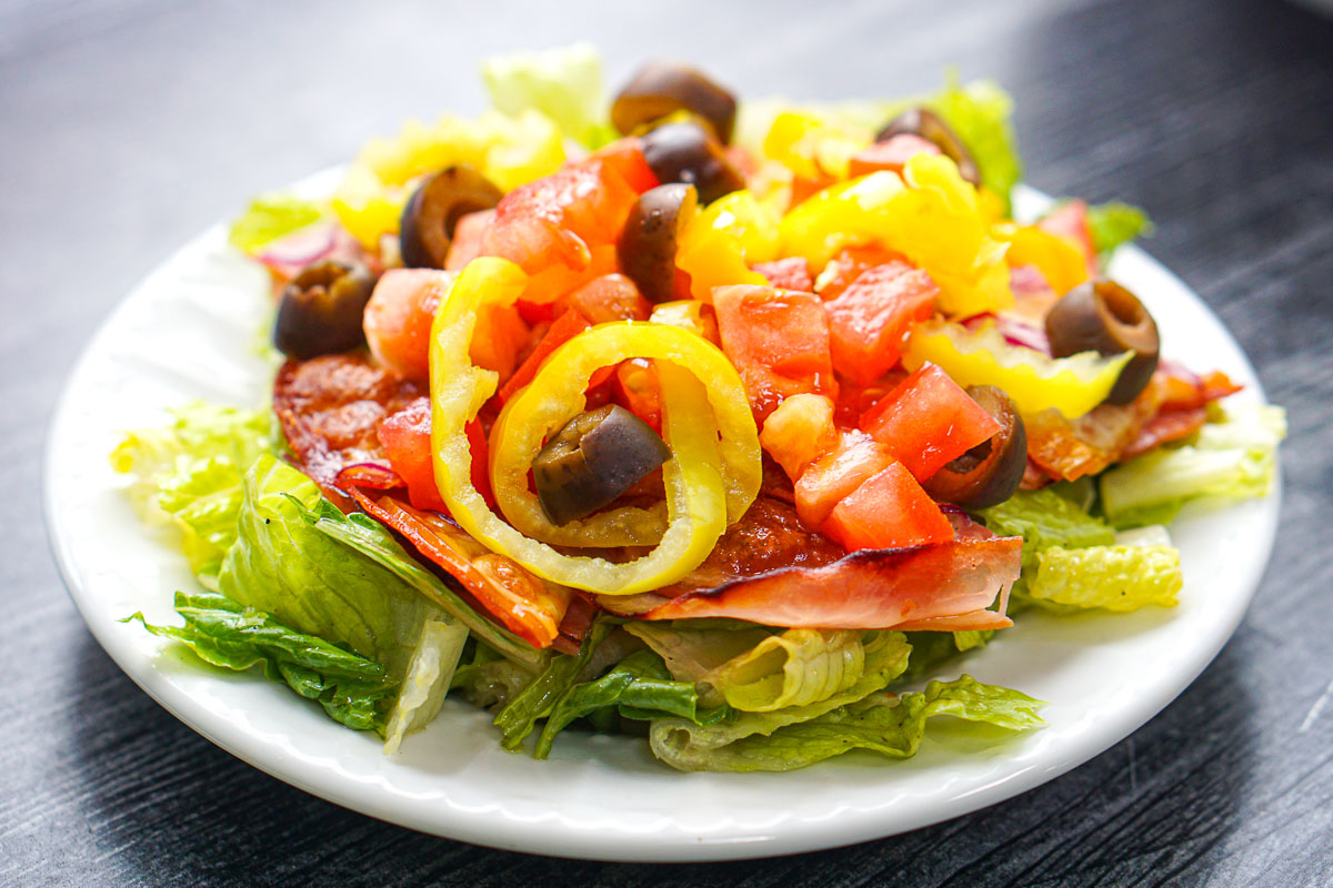 closeup of a white plate with keto Italian sub salad