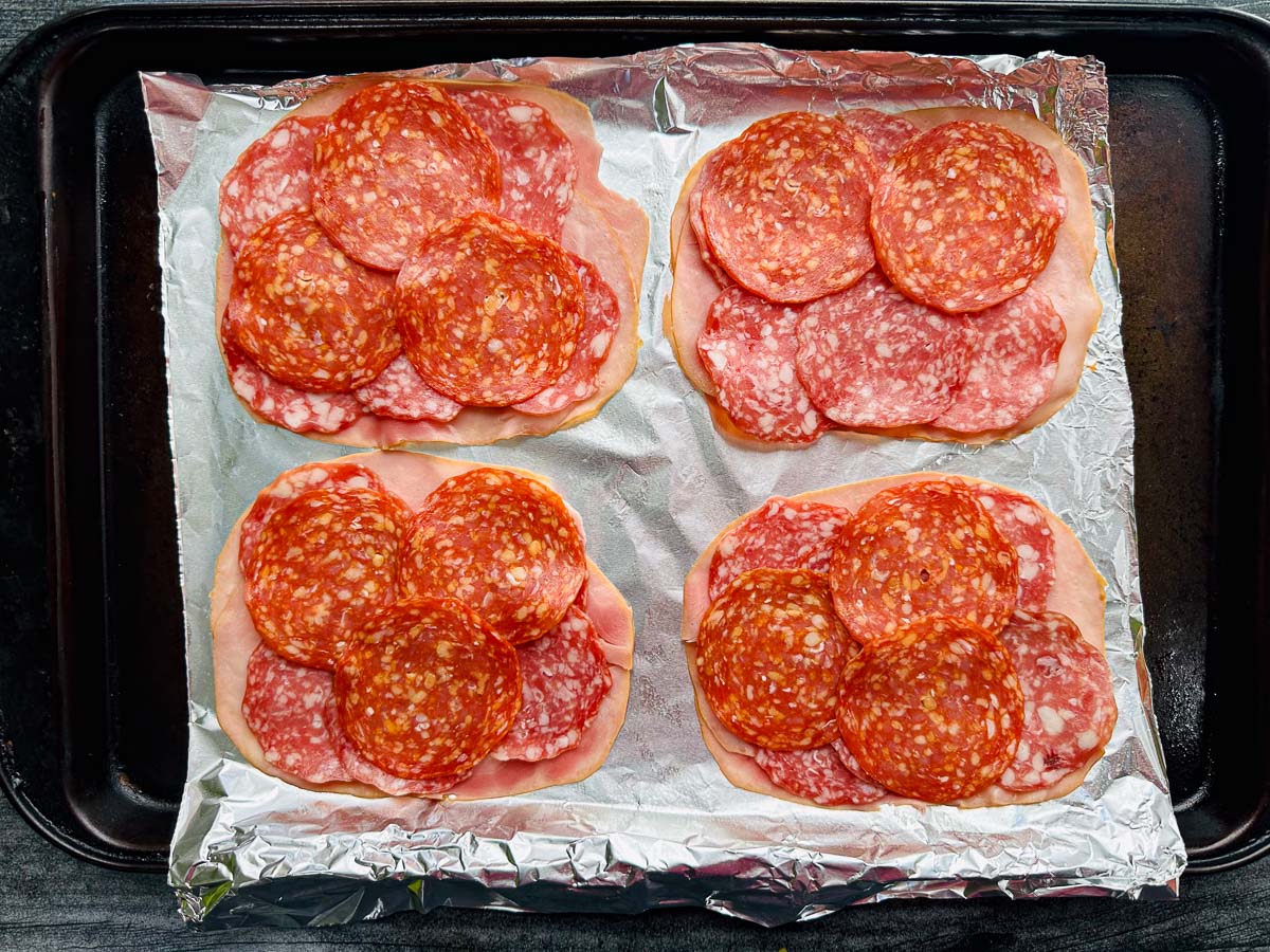 baking sheet with foil and 4 servings of Italian meats