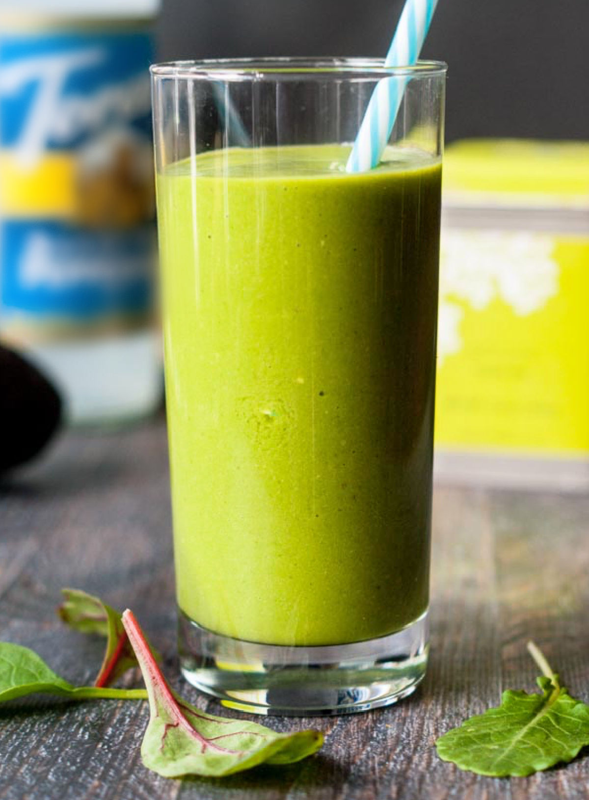 Closeup of a glass of green keto smoothie using mixed greens and green tea.