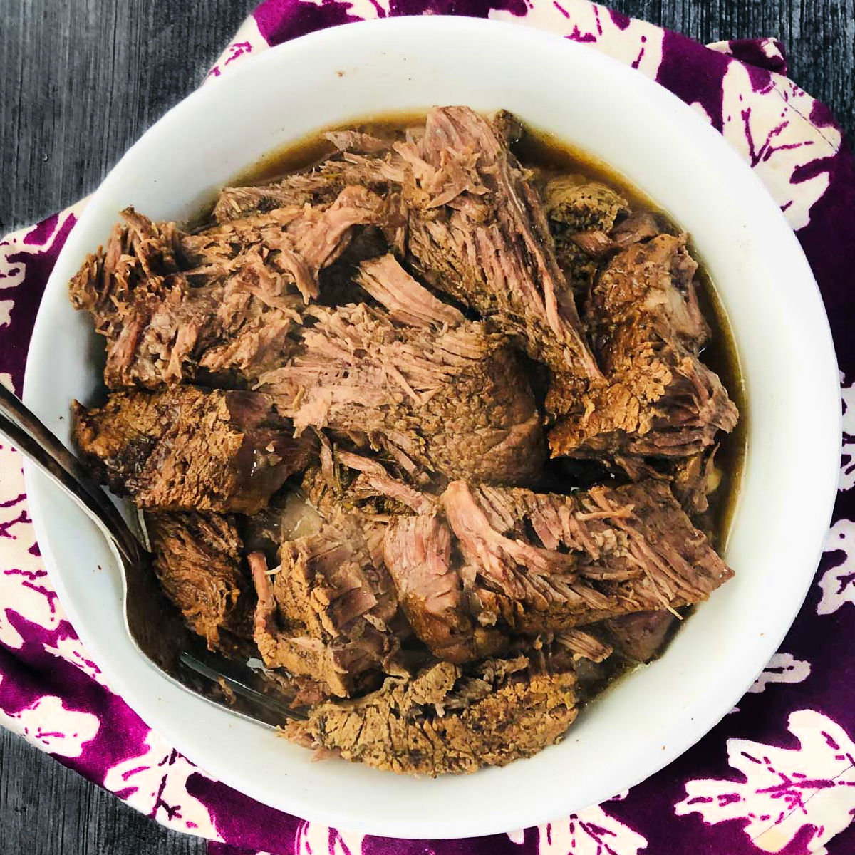 white bowl with instant pot chuck roast with balsamic