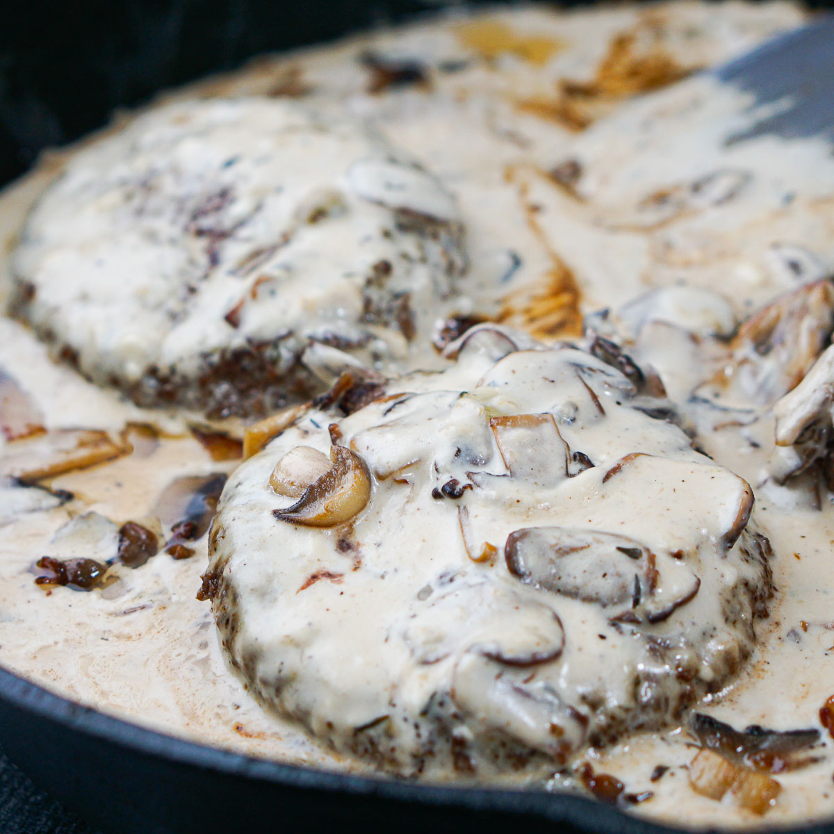 closeup of gruyere burgers with mushroom sauce