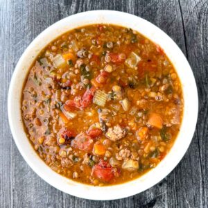 white bowl with sausage and lentil soup