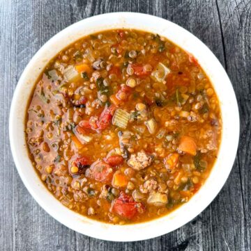 white bowl with sausage and lentil soup