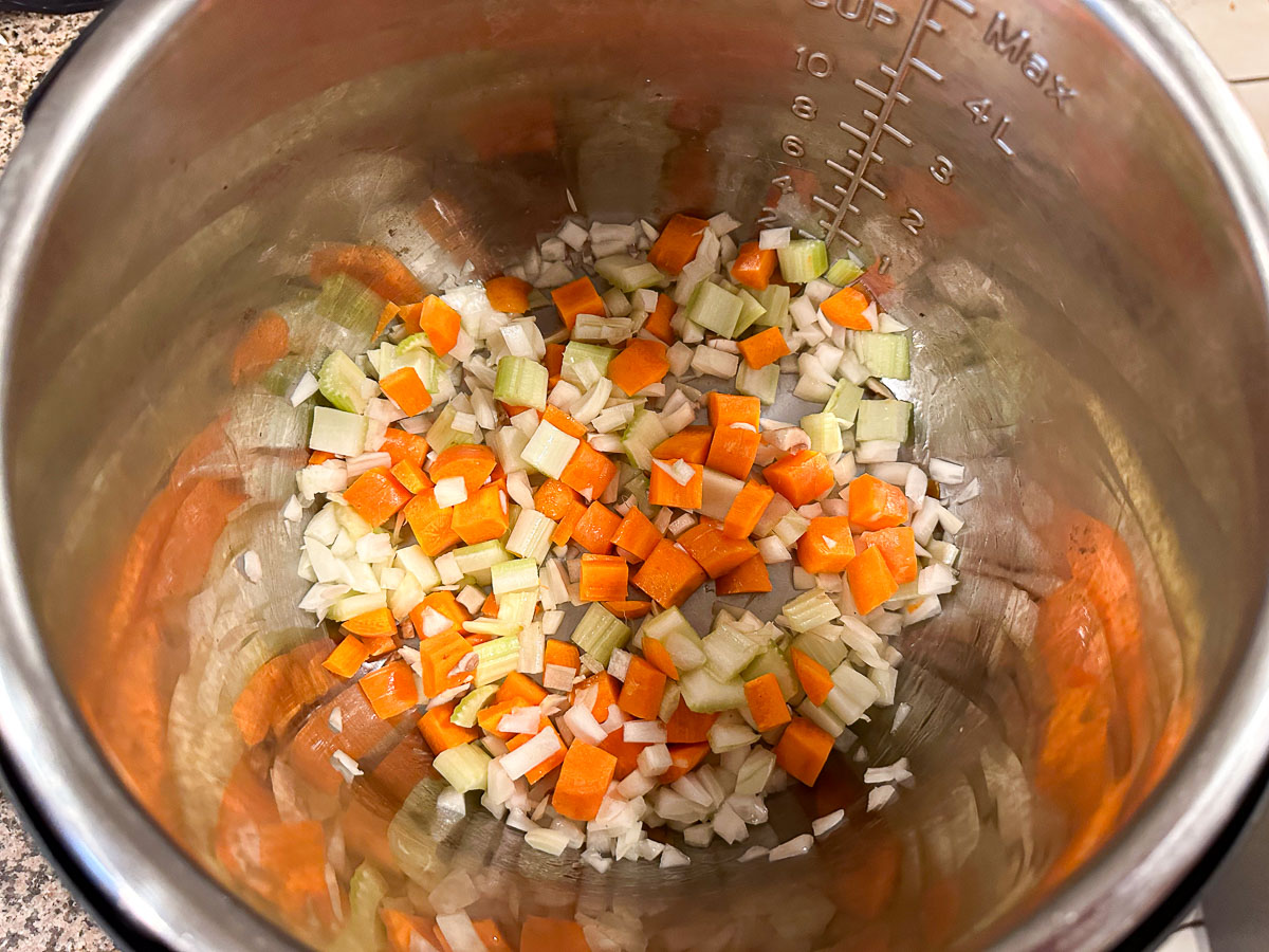 instant pot with sautéed onions and carrots