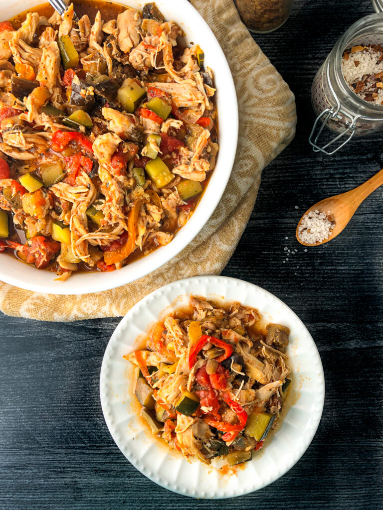 aerial view of a bowl and plate of slow cooker chicken stew