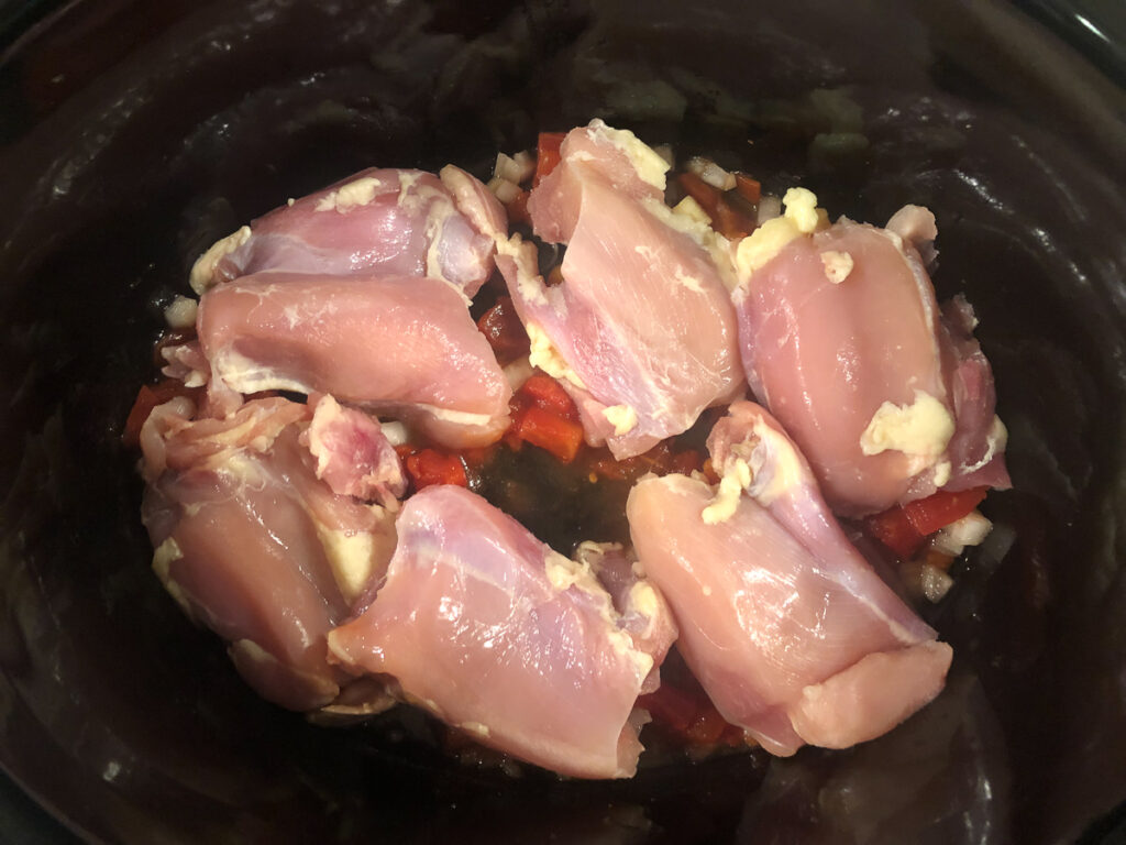 crockpot with tomatoes and chicken thighs