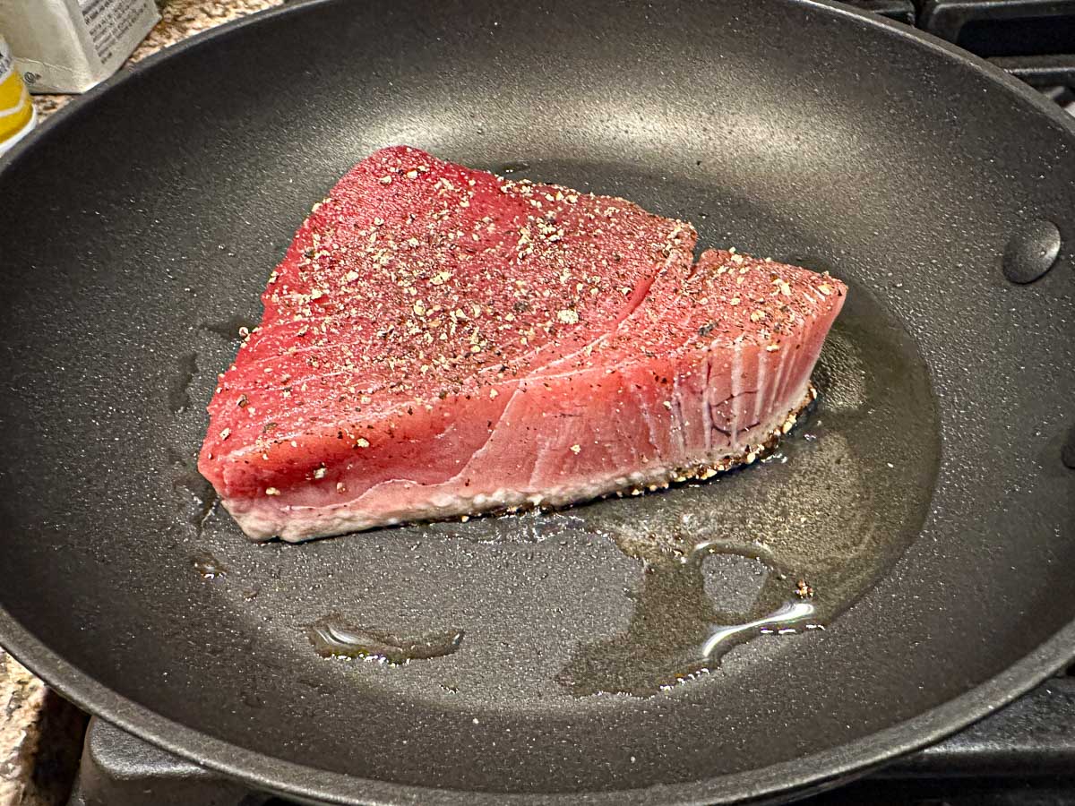 pan with the steak cooking ¼ the way up from the pan