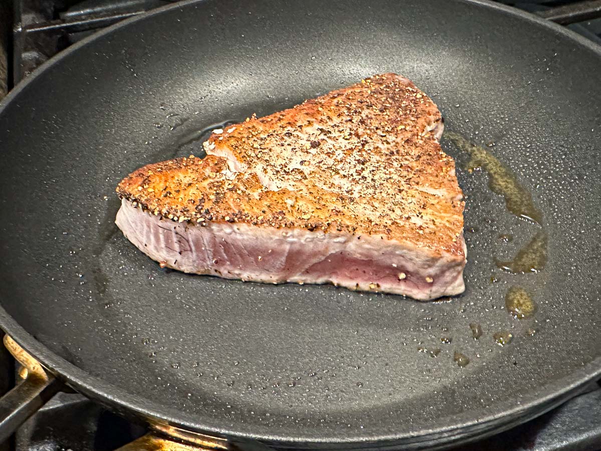 a pan with the steak just flipped over