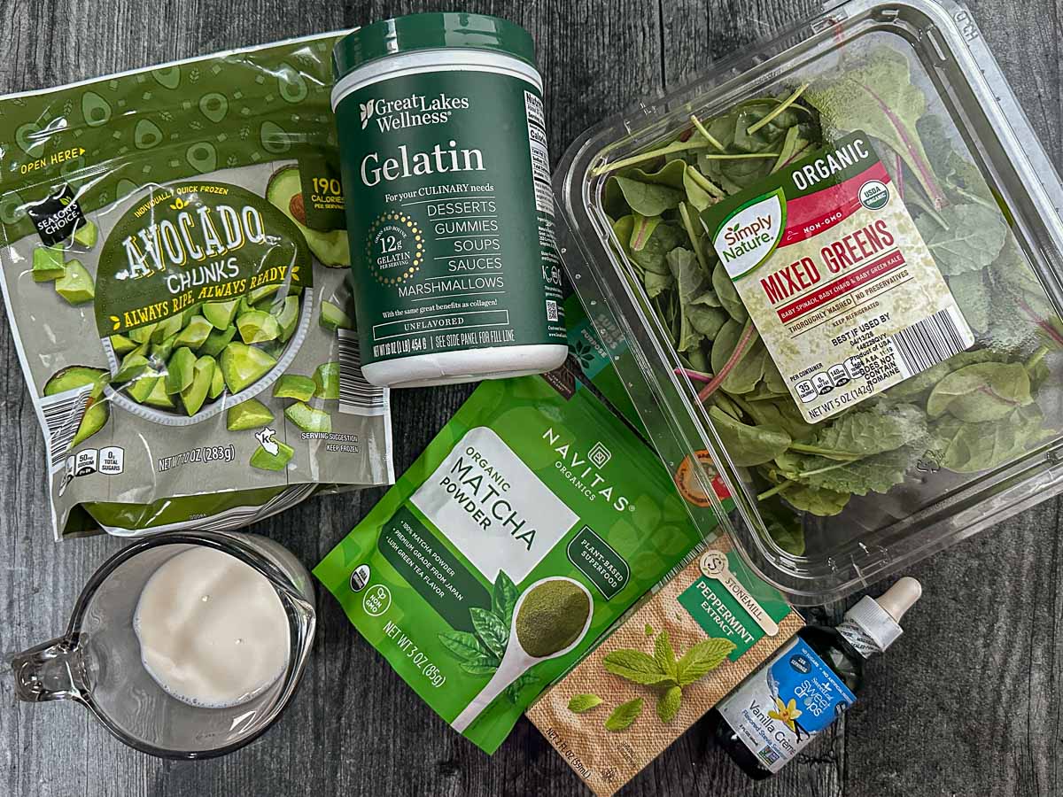 Recipe ingredients - frozen avocado, almond milk, gelatin, matcha green tea, mixed greens, vanilla stevia drops.