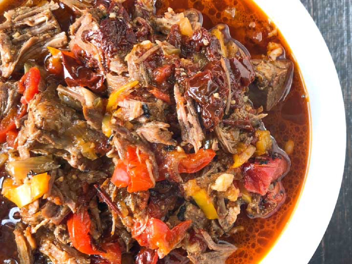 Spicy Barbacoa Beef Roast in the Instant Pot - easy, tasty dinner you can make in the slow cooker too! Aerial view of the finished dish in a white bowl.