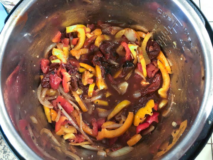 peppers , onions and spices in the instant pot