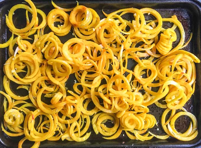 raw golden beet noodles on a baking pan