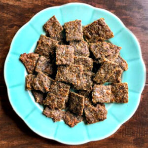 Aerial view of an aqua plate with a bunch of keto gyro meat chips.