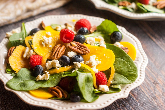 This pickled beet & gorgonzola spinach salad is full of delicious and nourishing ingredients such as berries, pecans and more.