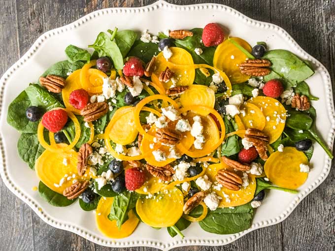 This pickled beet & gorgonzola spinach salad is full of delicious and nourishing ingredients such as berries, pecans and more.