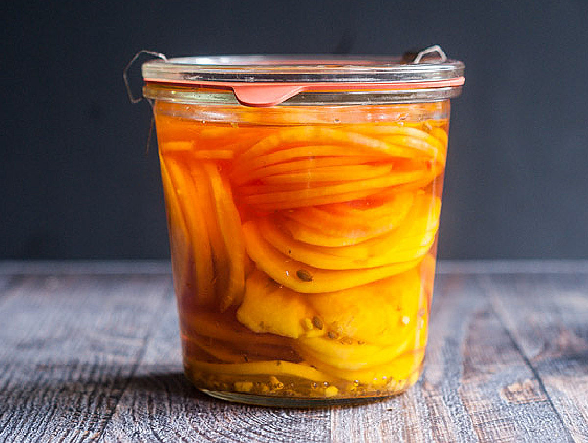 Pickled Beet & Gorgonzola Spinach Salad - bright, beautiful, delicious and nutritious! Closeup of a glass jar with quick pickled beet slices.