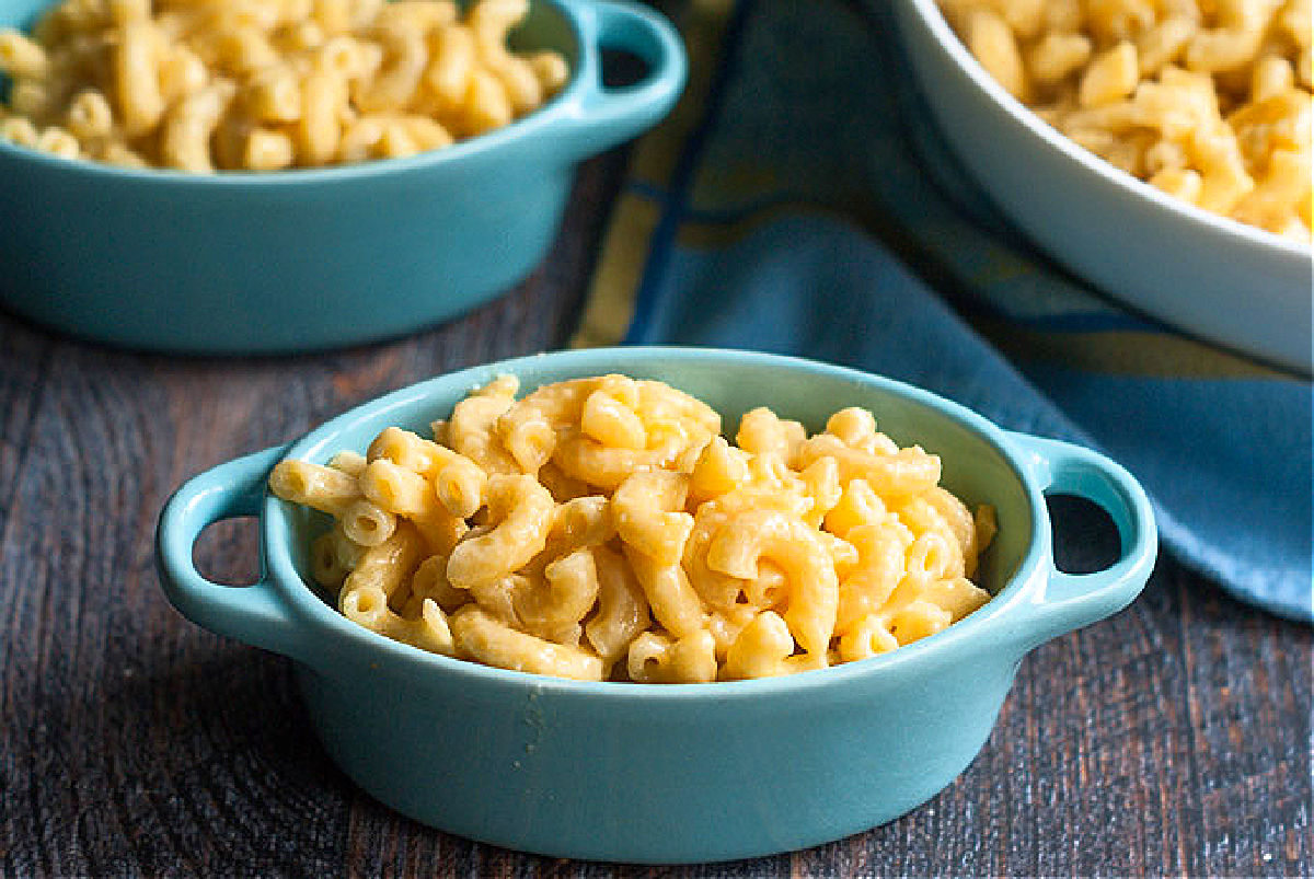 blue bowls with homemade cheddar Mac and cheese made in the Instant pot