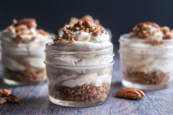 small jars with maple bacon low carb cheesecake and a few pecans scattered