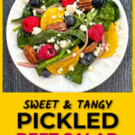 Closeup of a white plate with pickled beet salad with berries, pecans and gorgonzola cheese and text overlay.