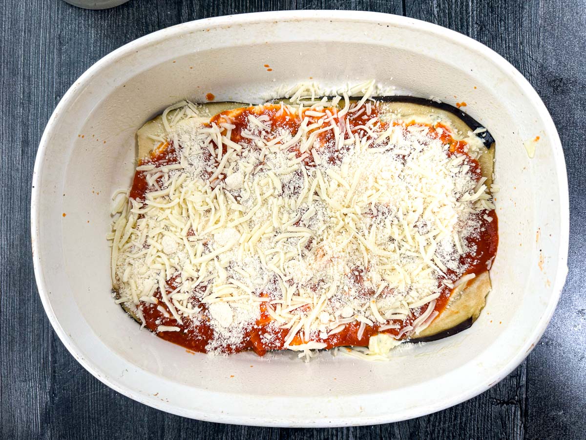 baking dish with eggplant layer with cheeses and sauce