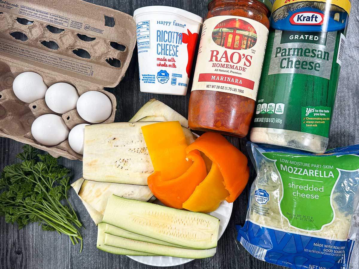 recipe ingredients - veggies, parsley, sauce, ricotta, eggs, parmesan and mozzarella