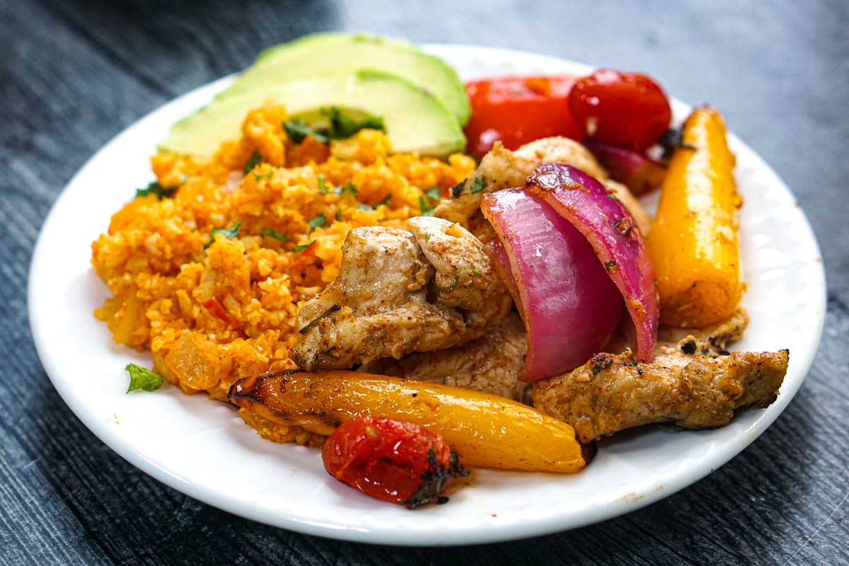 Closeup of a plate with the finished dish and some Mexican cauliflower rice.
