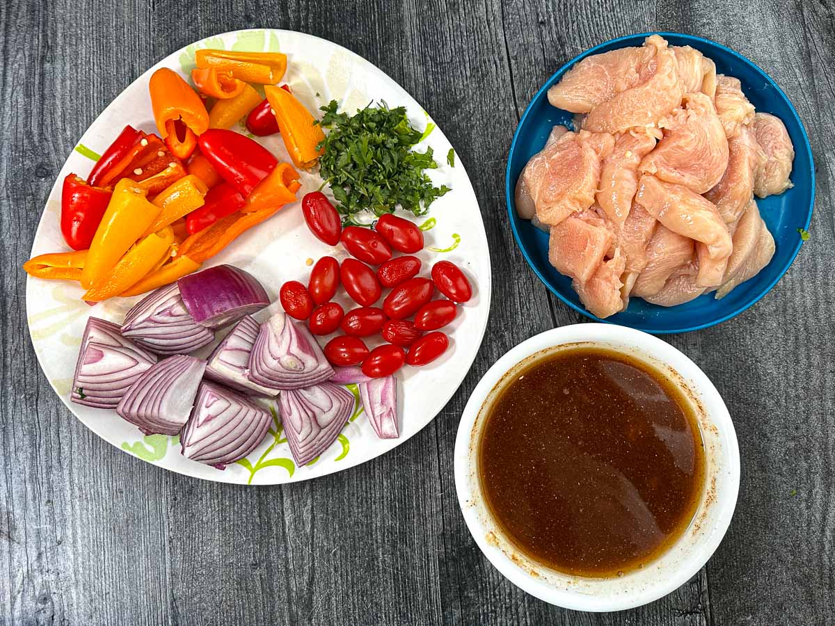 Grilled Chicken Fajita Kebabs - easy, healthy tasty dinner - make tacos or eat over a salad! Recipe ingredients - chicken, marinade, peppers, tomatoes and onion.