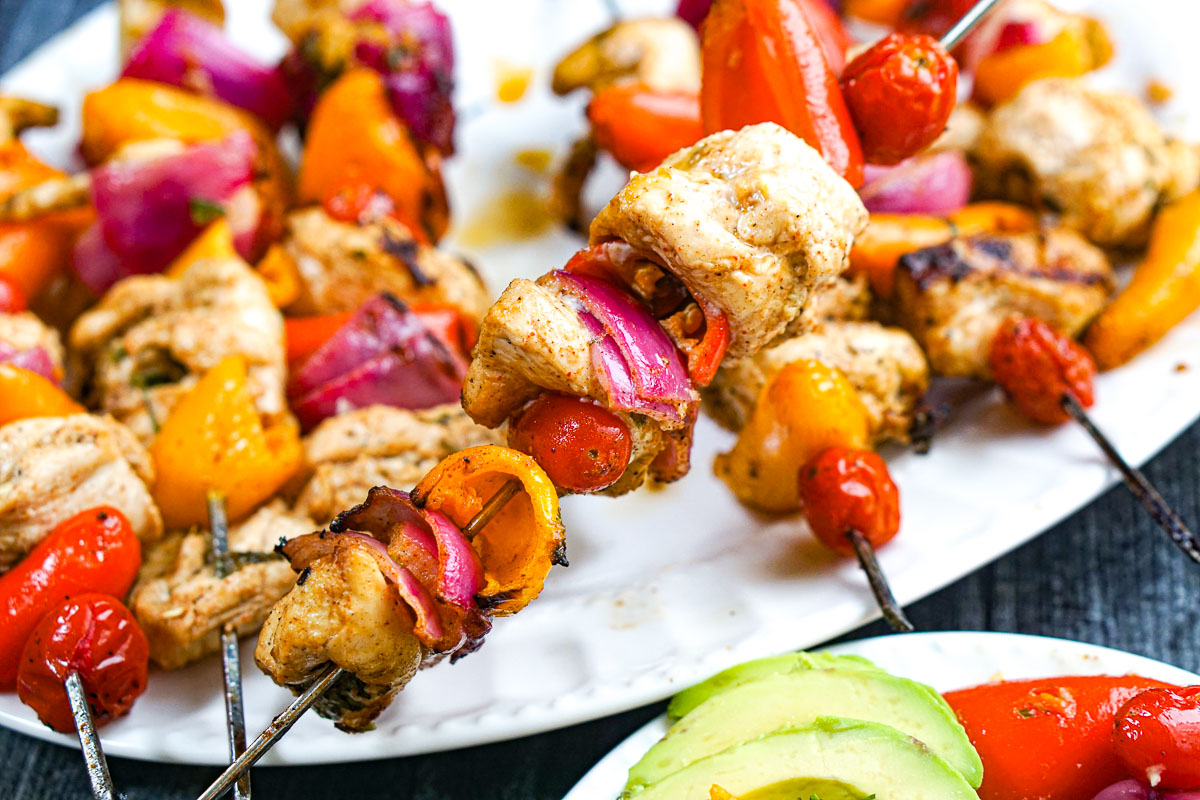 Grilled Chicken Fajita Kebabs - easy, healthy tasty dinner - make tacos or eat over a salad! Closeup of a skewer with the grilled meat and veggies.