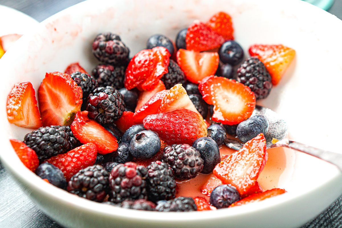 closeup of white bowl with sweetened berries