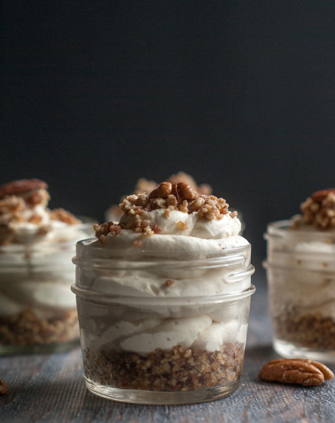 small jars with maple bacon low carb cheesecake and a few pecans scattered