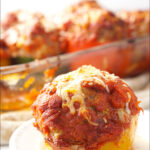 white plate and baking dish with meatball stuffed peppers