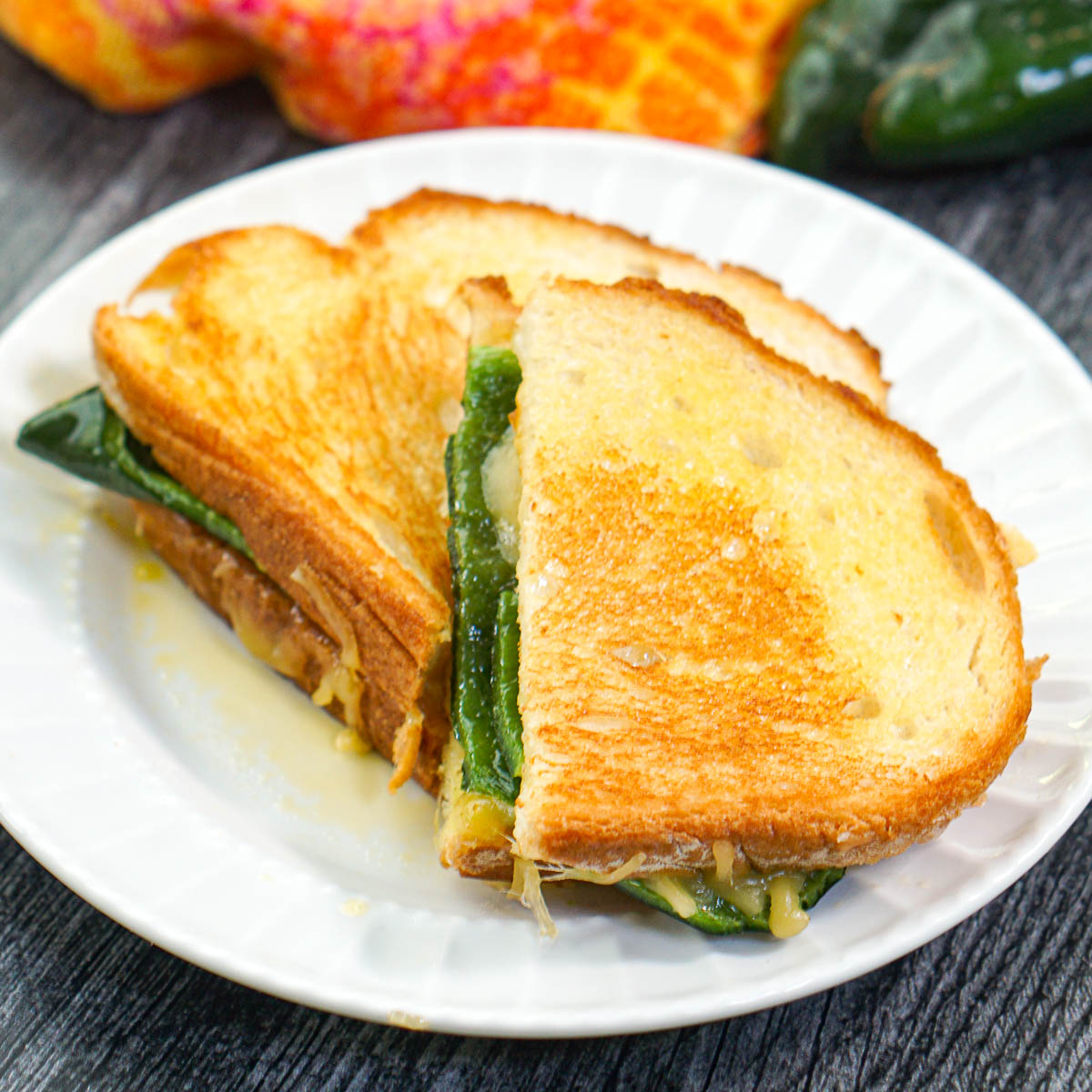 white plate with an apricot poblano grilled cheese sandwich