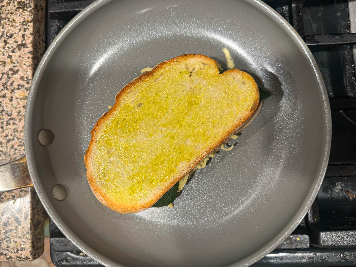 pan with a grilled cheese sandwich cooking