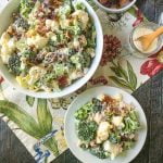 white bowls of keto broccoli cauliflower salad with bacon and text