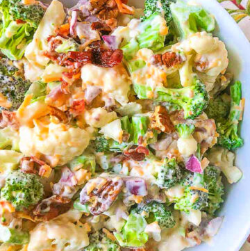 closeup of a bowl of loaded keto broccoli cauliflower salad with bacon