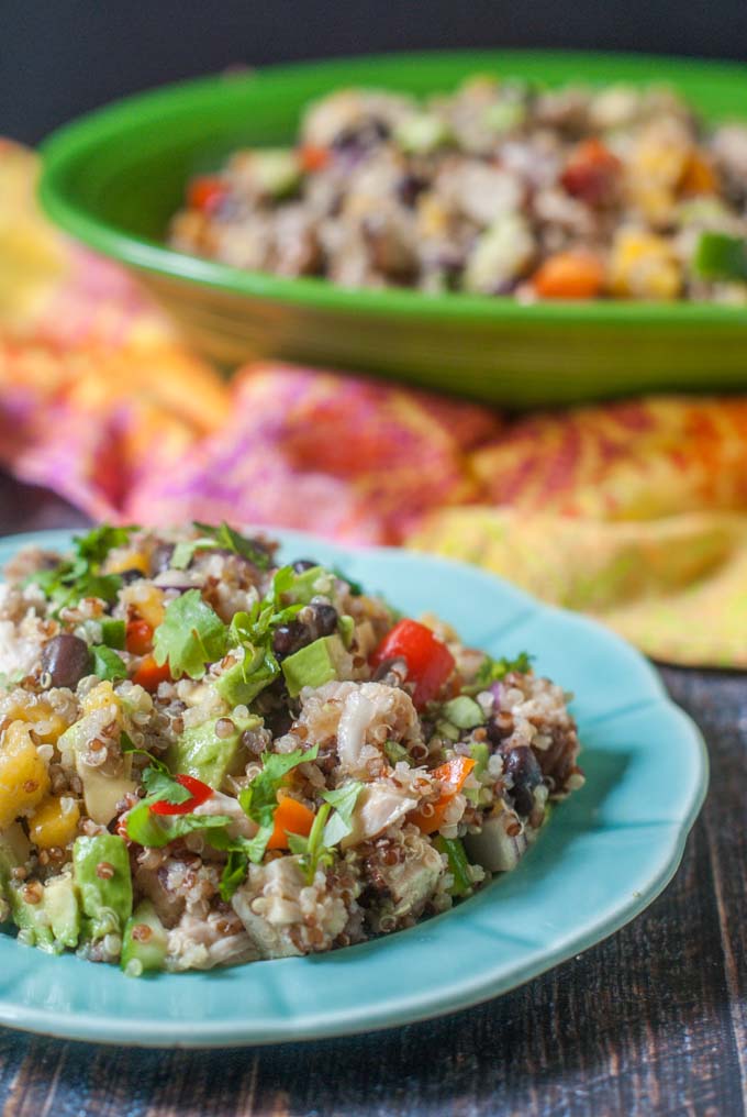 This Caribbean chicken quinoa salad is perfect for a summer dinner or picnic. Full of colorful fruit and vegetables and topped with spicy jerk chicken and chewy quinoa.