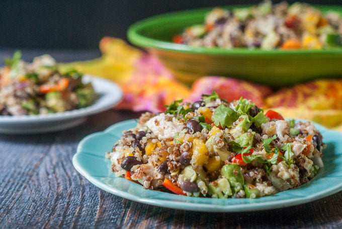 This Caribbean chicken quinoa salad is perfect for a summer dinner or picnic. Full of colorful fruit and vegetables and topped with spicy jerk chicken and chewy quinoa.