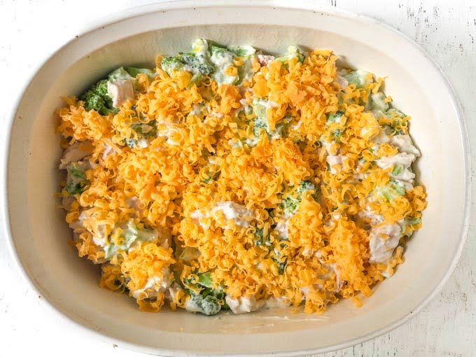 white baking dish with chicken broccoli casserole unbaked