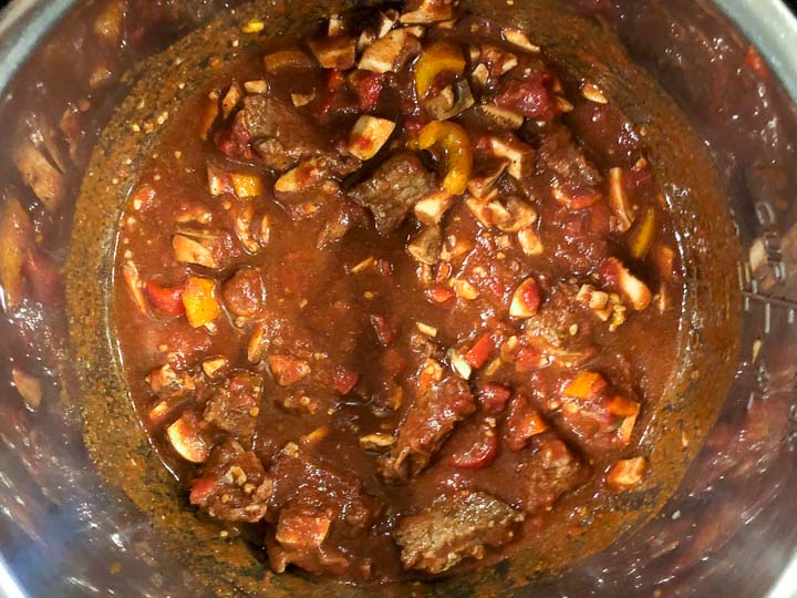 Instant Pot filled with chunky chili ingredients ready to cook